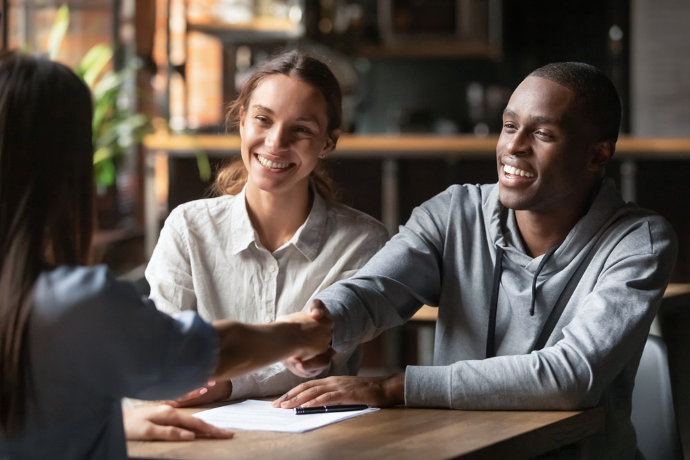 Happy,Young,Interracial,Couple,Shake,Hand,Of,Bank,Manager,Broker