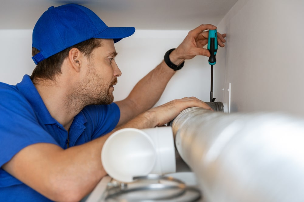 technician installing ventilation tubing