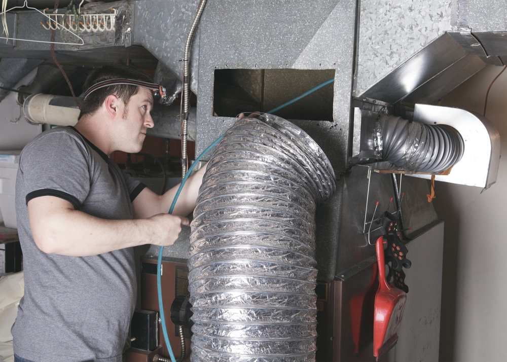 worker installing ventilation