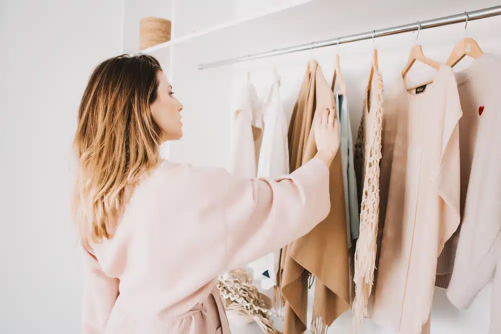 woman looking at clothes in wardrobe