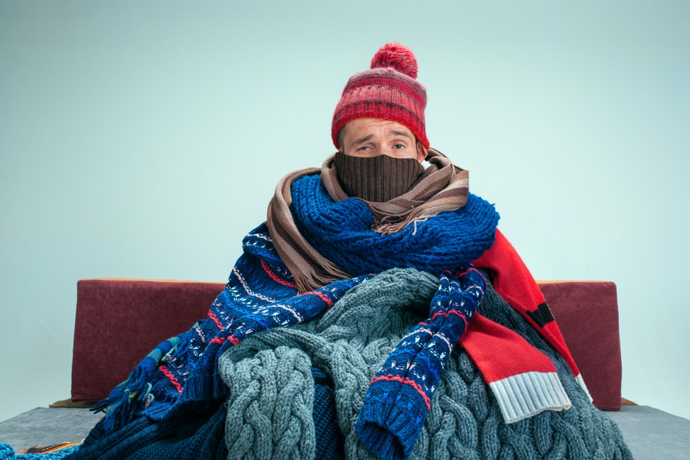 Bearded,Sick,Man,With,Flue,Sitting,On,Sofa,At,Home