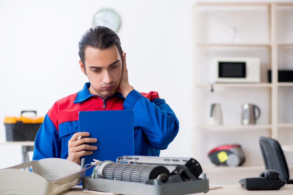 Young,Repairman,Repairing,Air-conditioner,At,Warranty,Center