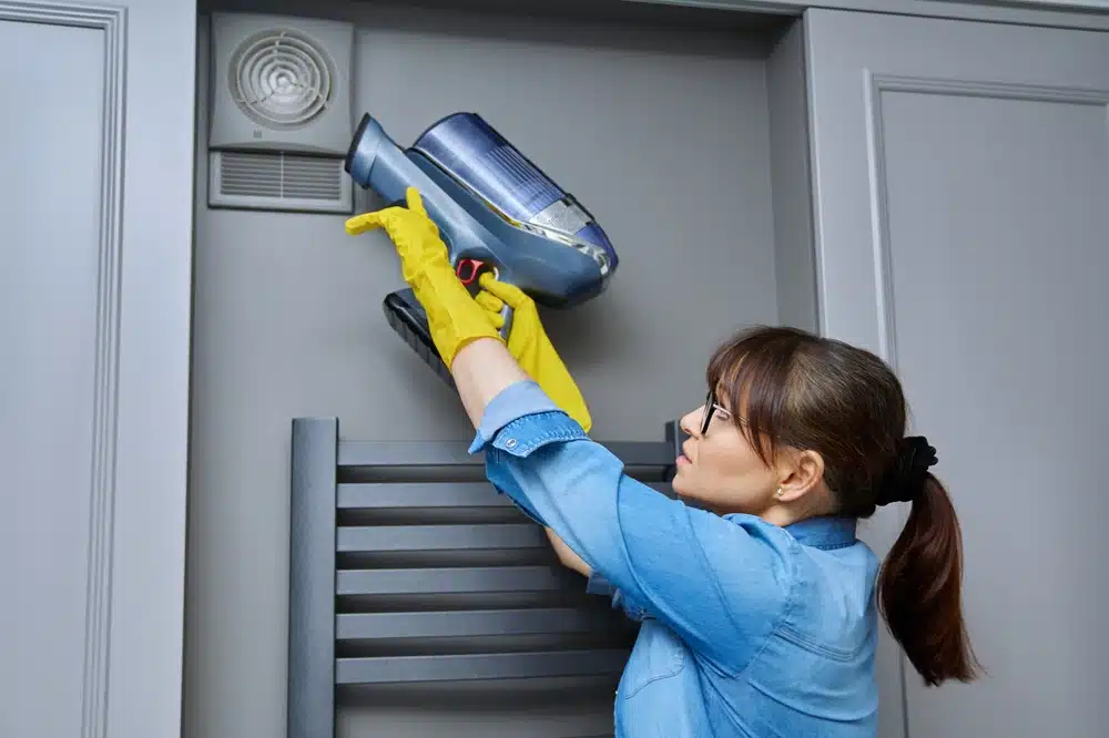 Can I clean my bathroom extractor fan without removing it?